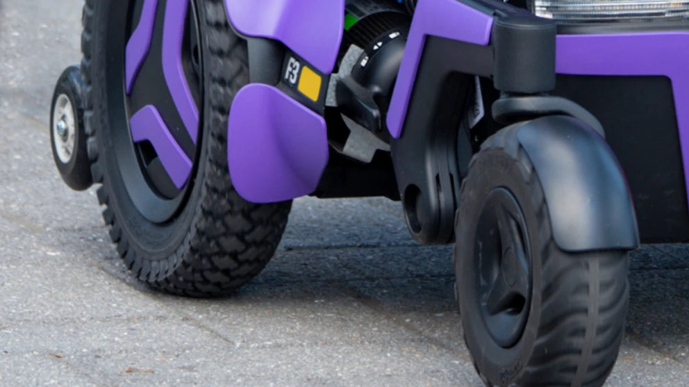 Wheels and suspension on a Permobil F3 Corpus power chair- purple colour